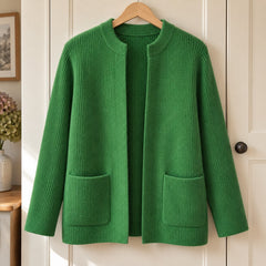 Betty Knitted Pocket Cardigan in Green on a hanger