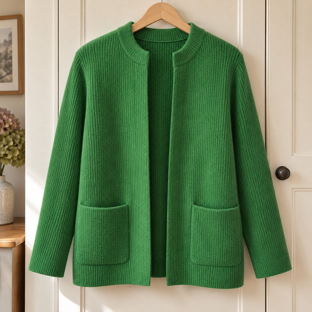 Betty Knitted Pocket Cardigan in Green on a hanger