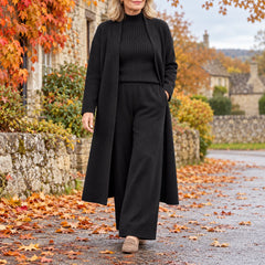A woman wearing the Celia Three-Piece Knit Set with Long Cardigan in Black