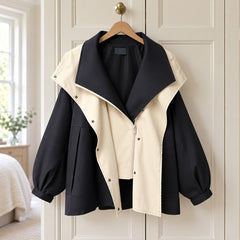The Della Hooded Contrast Zip Jacket in Black on a hanger