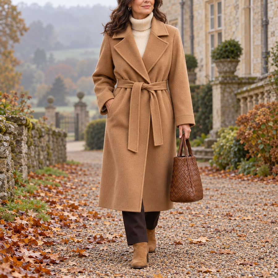 A woman wearing the Gina Long Belted Wrap Coat in Camel