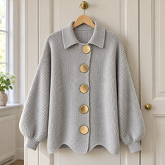 The Jacqueline Collared Gold Button Knit Cardigan in Grey on a hanger