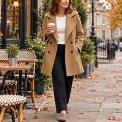 A woman wearing the Jacqui Relaxed Double Breasted Coat in Camel
