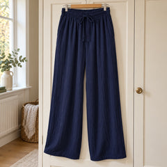 Jan Relaxed Wide-Leg Drawstring Trousers in Navy on a hanger