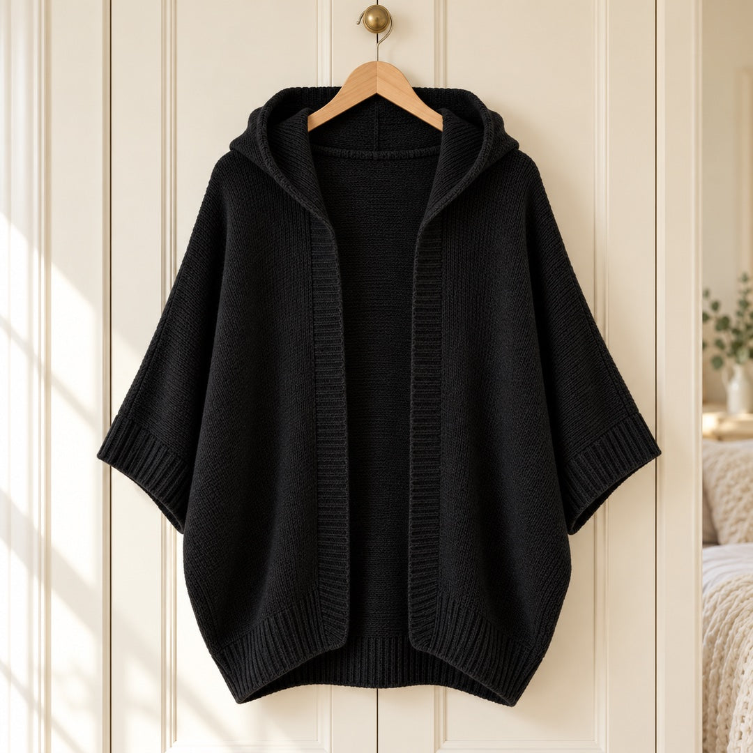 The Jane Hooded Batwing Knit Cardigan in Black on a hanger