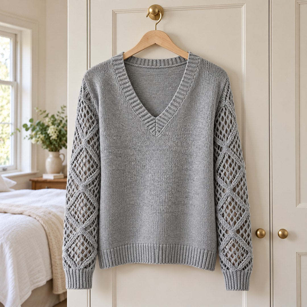 The Jeanette Open-Knit Sleeve V-Neck Jumper in Grey on a hanger