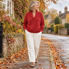 A woman wearing the Joan Draped Shawl Collar Knit Jumper in Red