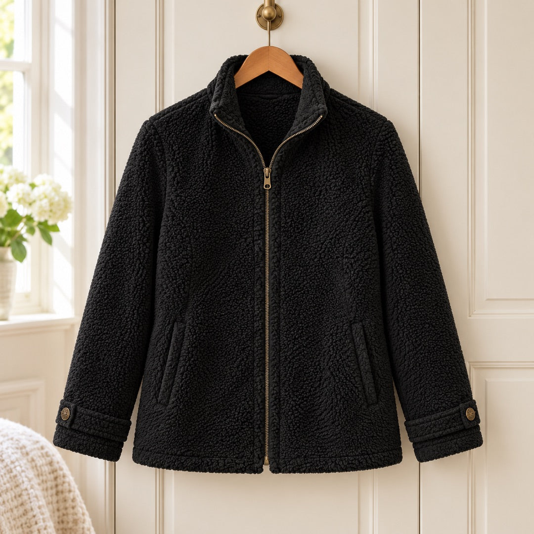 The Joy Cosy Teddy Fleece Stand Collar Jacket in Black on a hanger