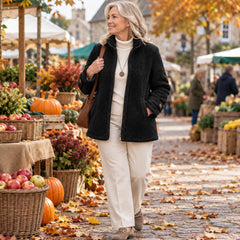 A woman wearing the Joy Cosy Teddy Fleece Stand Collar Jacket in Black