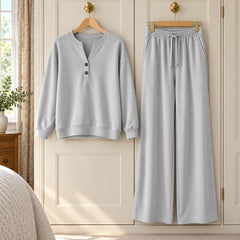 The June Button Neck Jumper and Wide-Leg Trouser Set in Light Grey on a hanger