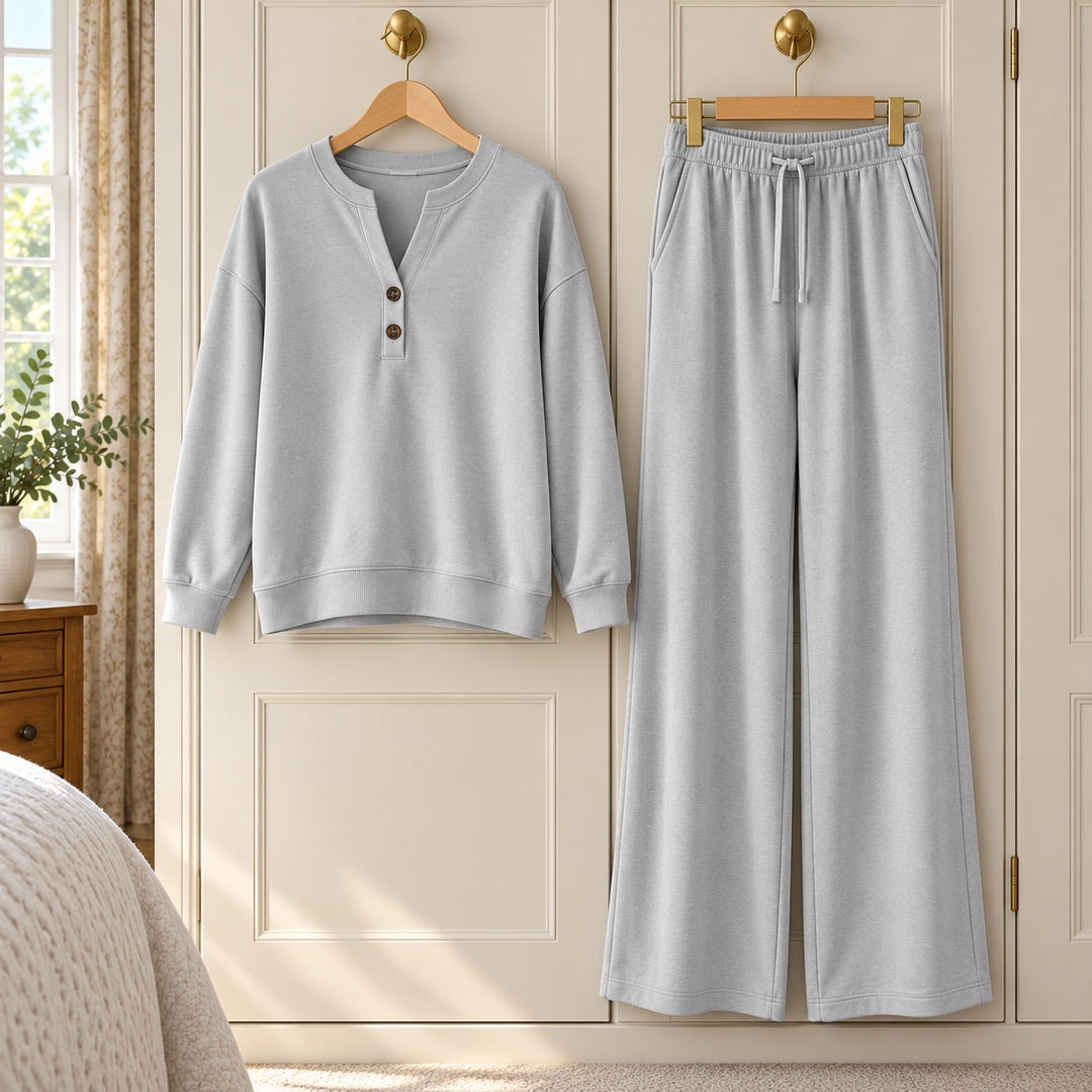 The June Button Neck Jumper and Wide-Leg Trouser Set in Light Grey on a hanger