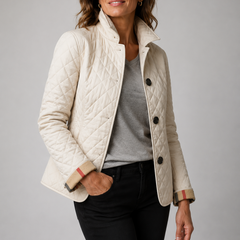 A woman wearing the Lesley Diamond Quilted Button Jacket in Cream