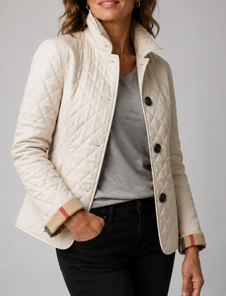 A woman wearing the Lesley Diamond Quilted Button Jacket in Cream