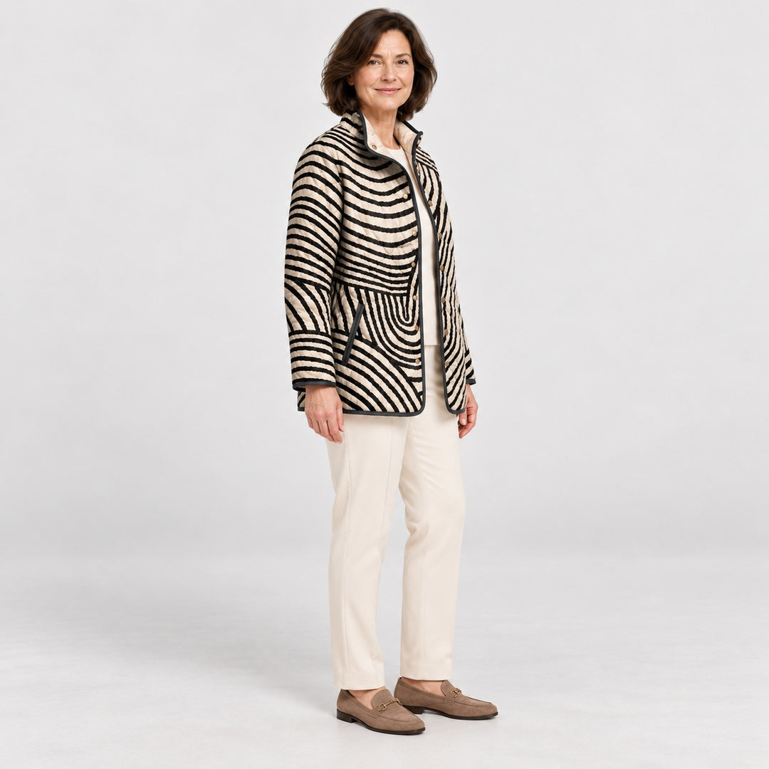 Side view of the Lisa Swirl Print Quilted Stand Collar Jacket in Black Cream Swirl