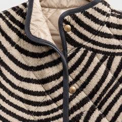 Detail of the Lisa Swirl Print Quilted Stand Collar Jacket in Black Cream Swirl