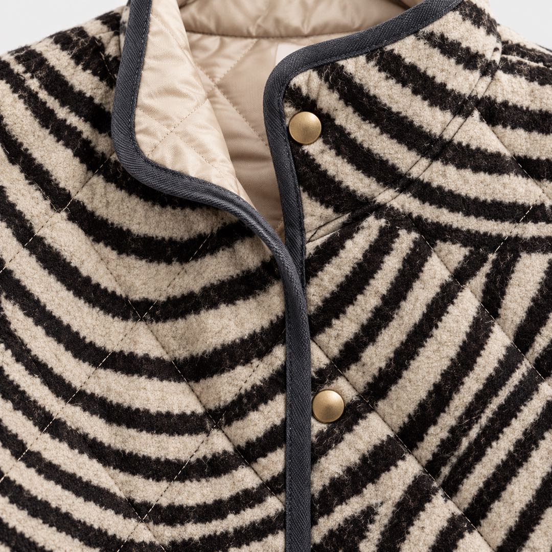 Detail of the Lisa Swirl Print Quilted Stand Collar Jacket in Black Cream Swirl