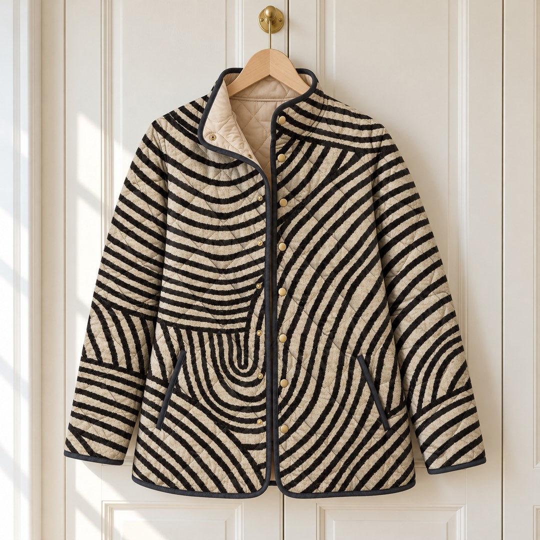 The Lisa Swirl Print Quilted Stand Collar Jacket in Black Cream Swirl on a hanger