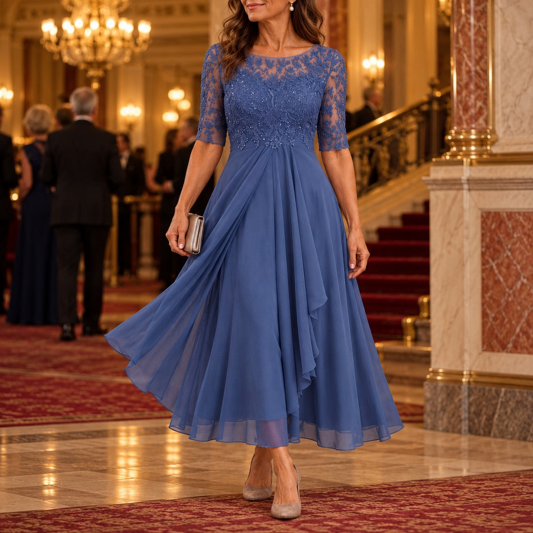 A woman wearing the Lynette Lace Bodice Tiered Chiffon Midi Dress in Blue