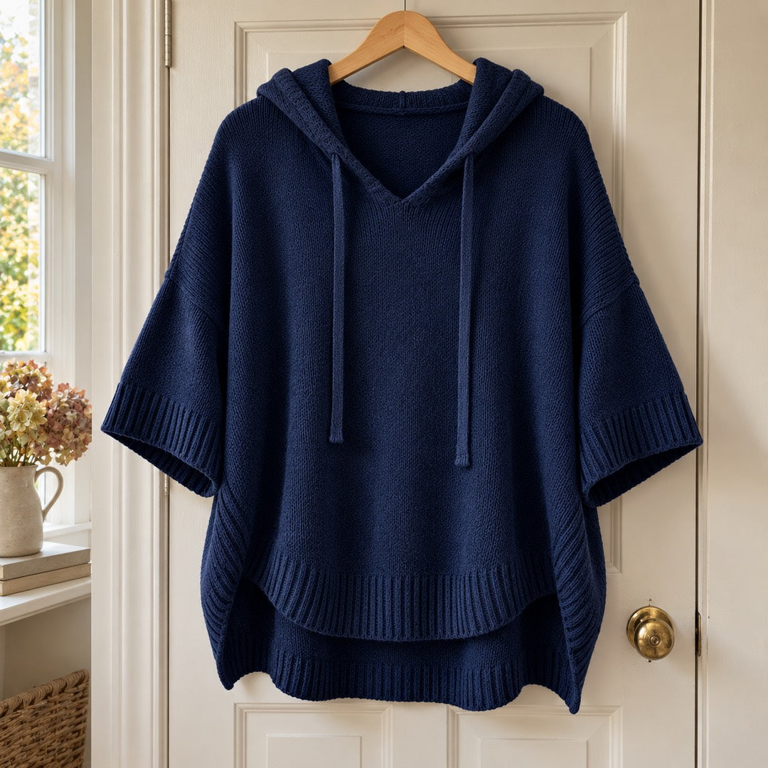 Maggie Hooded Knit Poncho Jumper in Navy on a hanger
