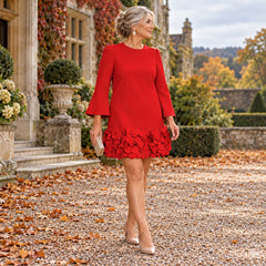 A woman wearing the Marcia Flared Sleeve Dress with Flower Hem in Red