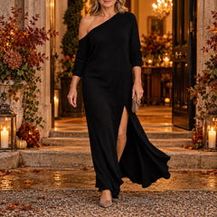 A woman wearing the Marilyn One-Shoulder Knit Maxi Dress with Side Split in Black