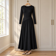 The Nicola Gathered Waist Long Sleeve Knit Maxi Dress in Black on a hanger