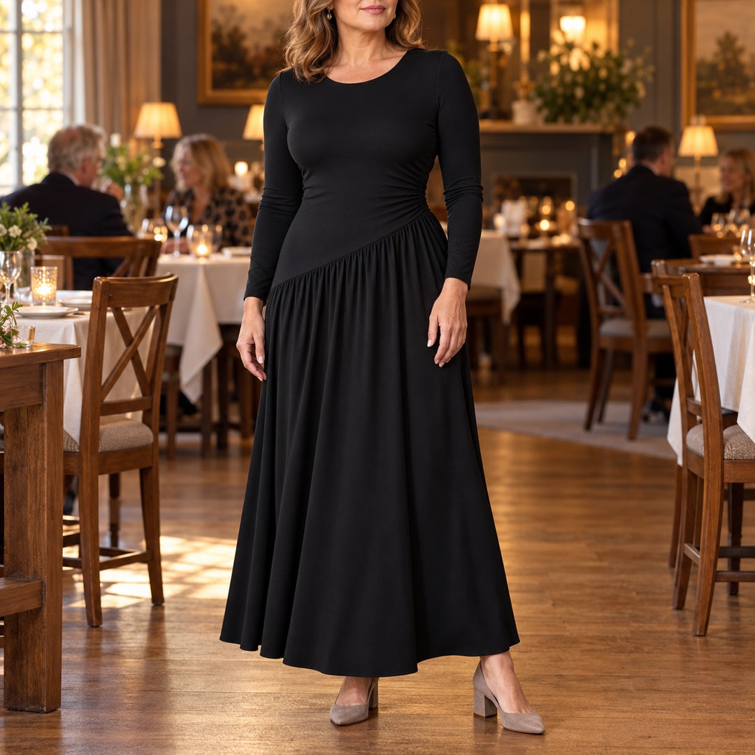 A woman wearing the Nicola Gathered Waist Long Sleeve Knit Maxi Dress in Black