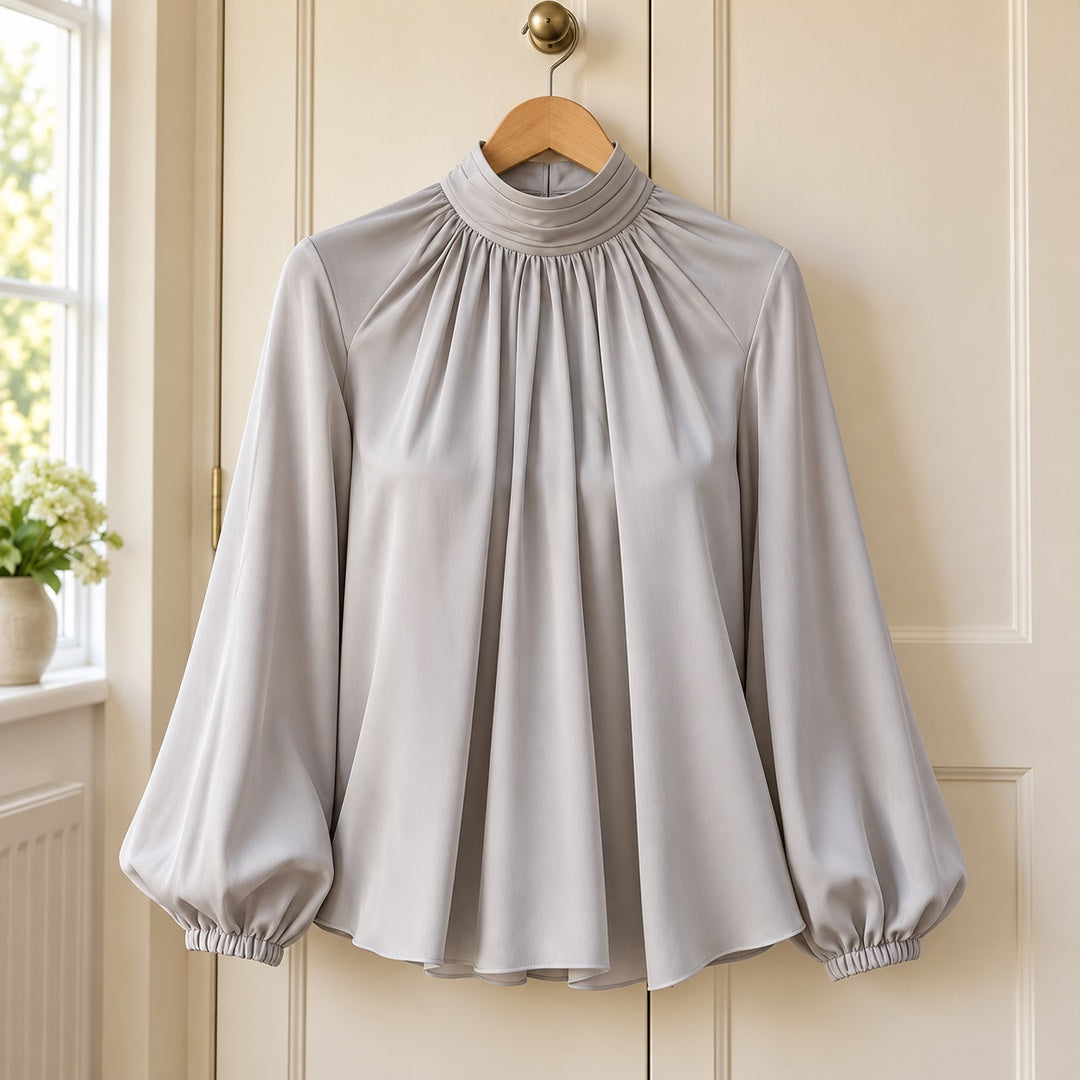 Patsy High Neck Pleated Blouse with Balloon Sleeves in Grey on a hanger
