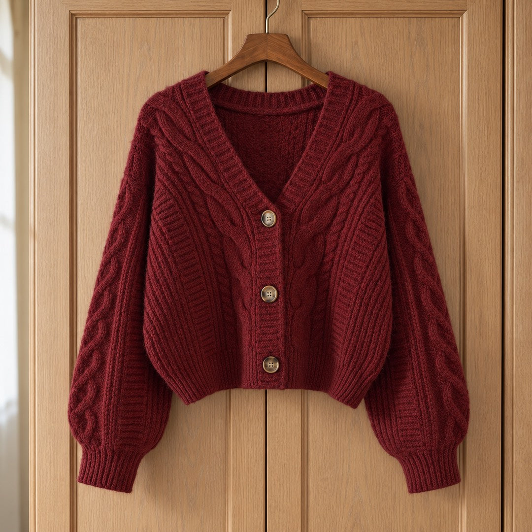 The Sheila Cropped Cable Knit Cardigan on a hanger