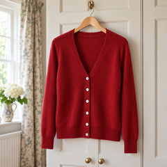 The Tanya V-Neck Button Front Fine Knit Cardigan on a hanger